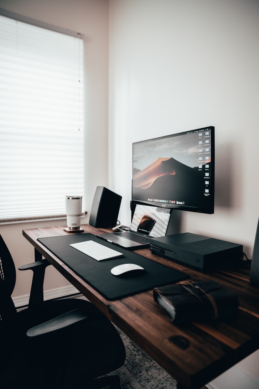 An empty desk by a window at the end of the day